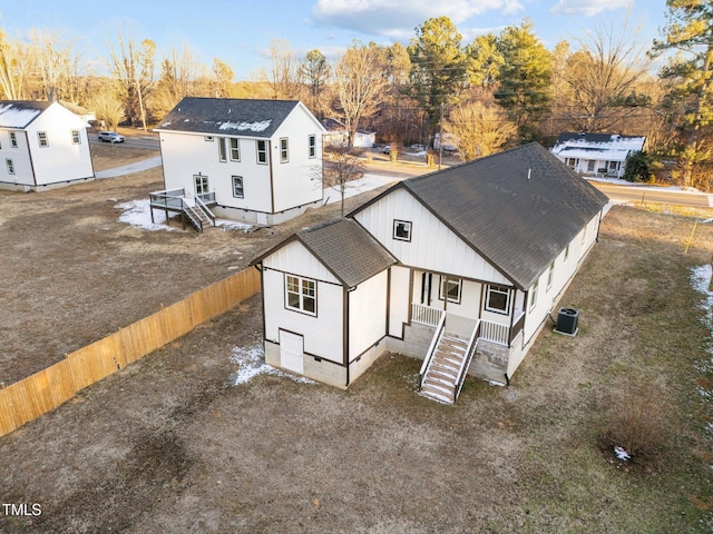 exterior space with cooling unit, a shingled roof, fence, stairway, and crawl space