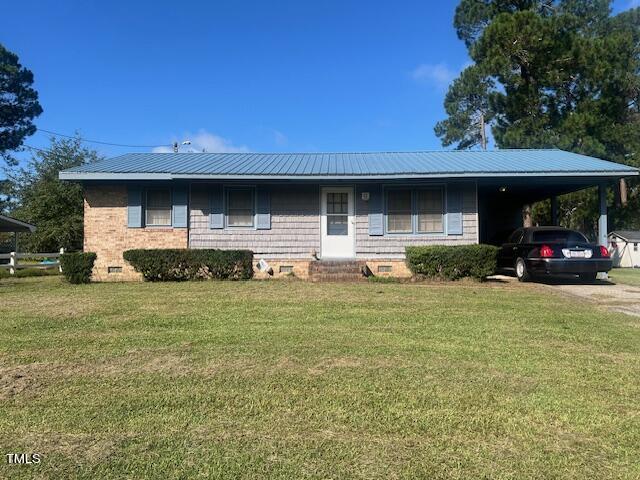 108 Gulf Dr, Dunn, NC 28334 - single story home with crawl space, a front yard, a carport, driveway, and metal roof