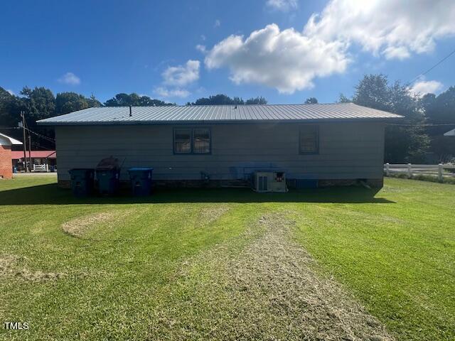 108 Gulf Dr, Dunn, NC 28334 - rear view of property with a yard, cooling unit, and metal roof
