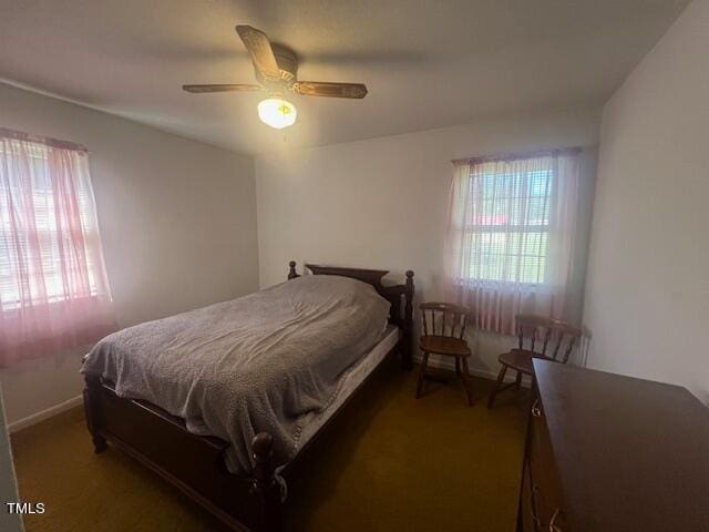 bedroom featuring dark carpet and ceiling fan