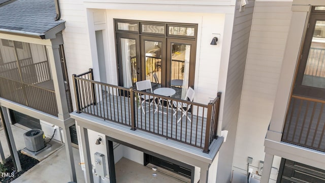 doorway to property with central AC unit and a balcony