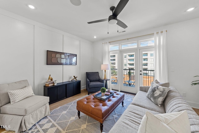 living room with ceiling fan and light hardwood / wood-style floors