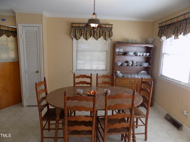 dining area featuring crown molding