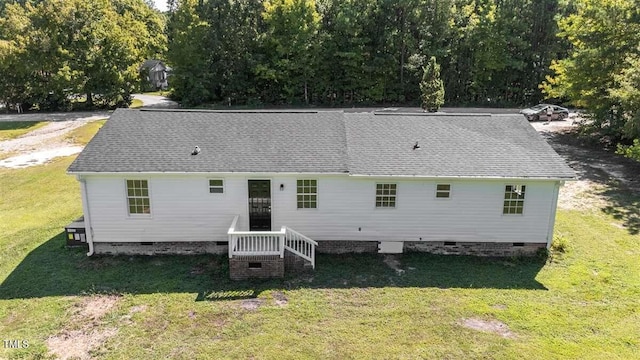 rear view of house featuring a yard