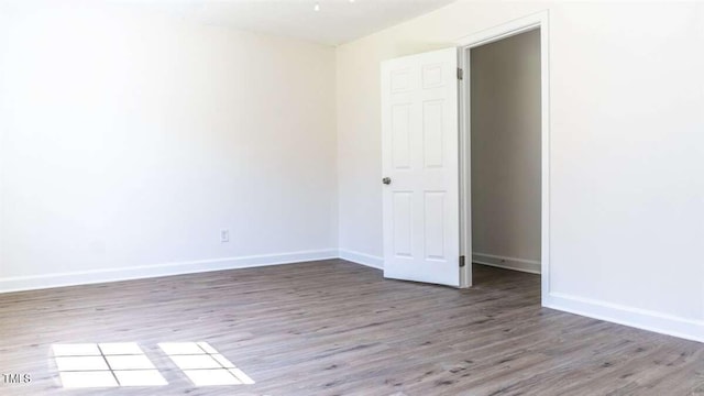 spare room featuring hardwood / wood-style flooring