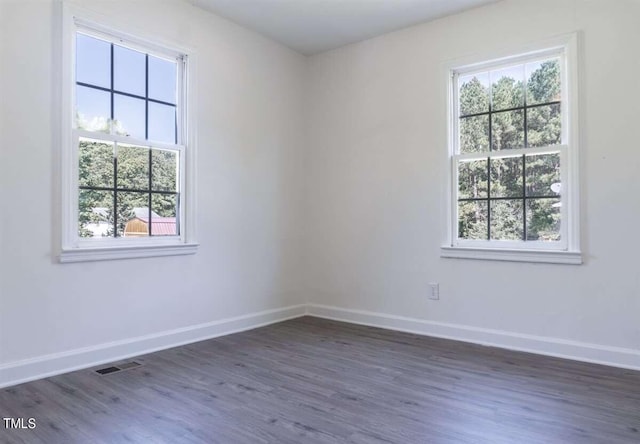 unfurnished room featuring dark hardwood / wood-style floors