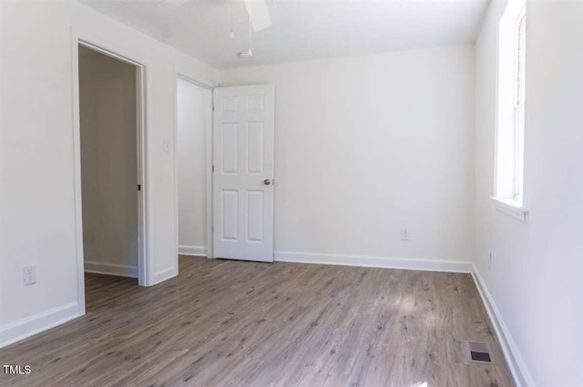 unfurnished room featuring ceiling fan and light hardwood / wood-style flooring