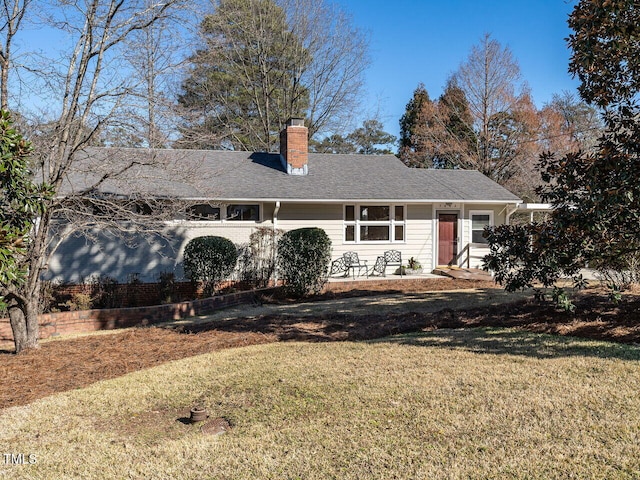 ranch-style home featuring a front yard