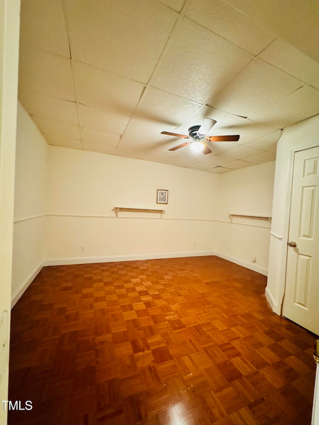 unfurnished room featuring a drop ceiling and ceiling fan