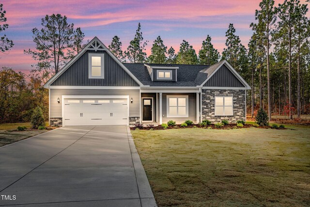 craftsman-style home featuring a yard and a garage