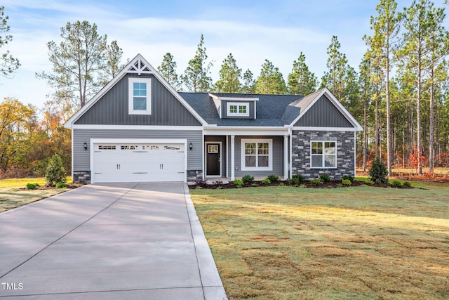 craftsman-style house featuring a garage and a front lawn