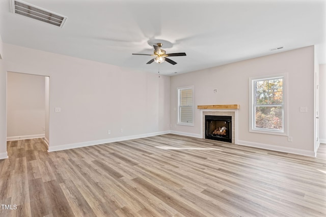 unfurnished living room with light hardwood / wood-style flooring and ceiling fan