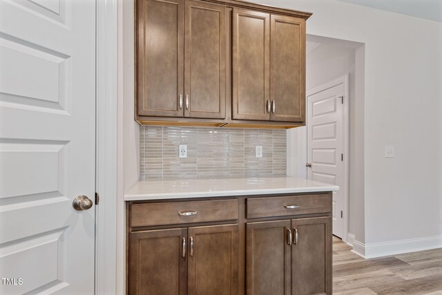 kitchen featuring tasteful backsplash and light hardwood / wood-style floors