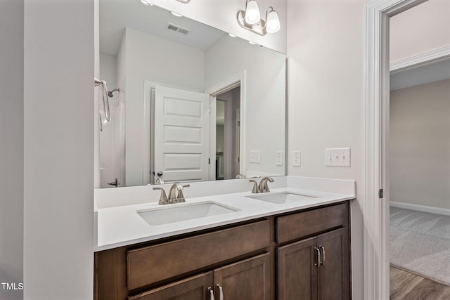 bathroom with vanity and hardwood / wood-style flooring