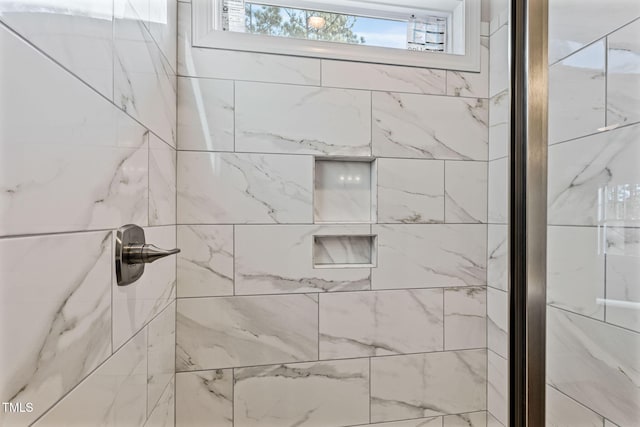 interior details featuring a shower with door