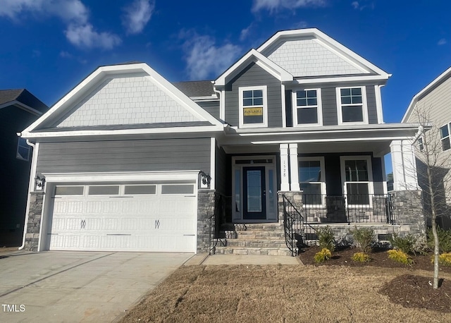 craftsman-style home with a porch and a garage