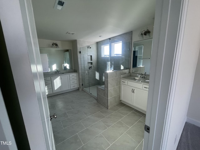 bathroom with vanity, tile patterned floors, and a shower with door