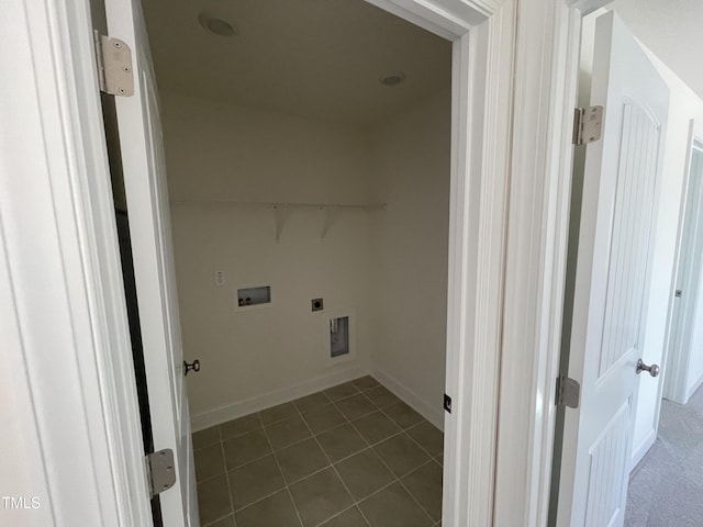 laundry area featuring hookup for an electric dryer, hookup for a washing machine, and dark tile patterned floors