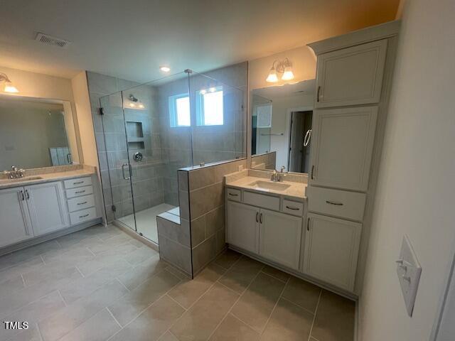 1528 Maelyn Way, Fuquay Varina, NC 27526 - full bathroom featuring a shower stall, two vanities, and tile patterned floors