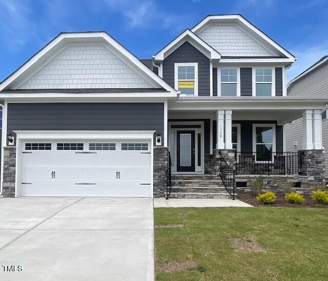 1528 Maelyn Way, Fuquay Varina, NC 27526 - craftsman inspired home with concrete driveway, a porch, a front yard, stone siding, and an attached garage