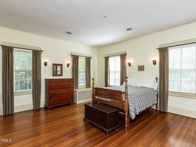 bedroom featuring radiator and dark wood-type flooring