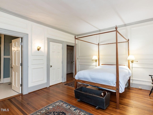 bedroom with ornamental molding and hardwood / wood-style flooring