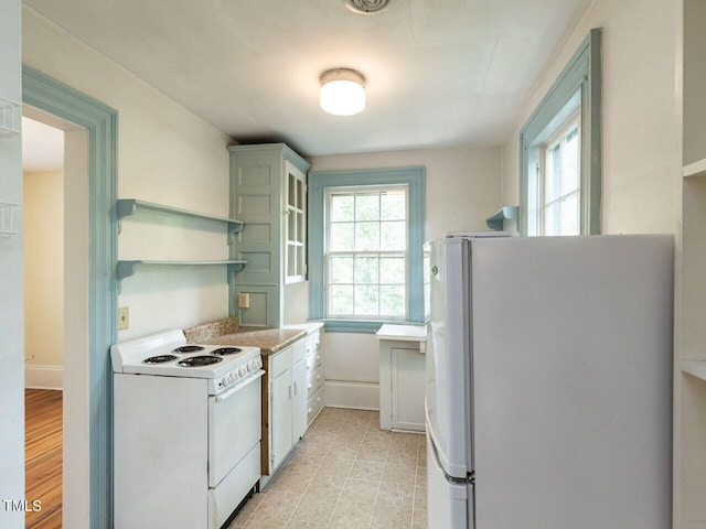 kitchen featuring white appliances and white cabinetry