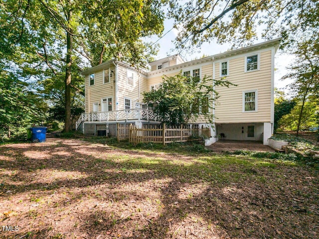 rear view of property featuring a wooden deck