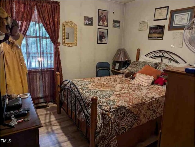 bedroom with hardwood / wood-style floors