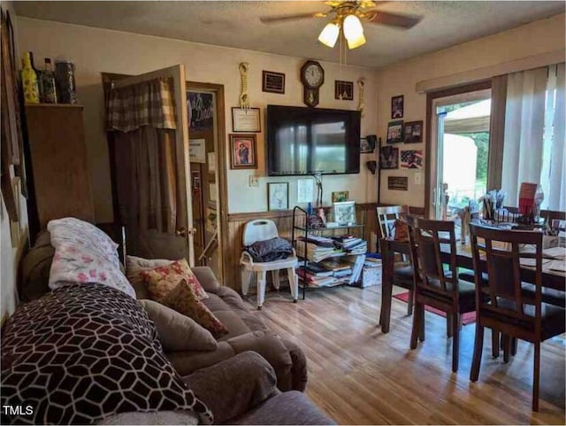 dining space featuring ceiling fan, hardwood / wood-style flooring, and a textured ceiling