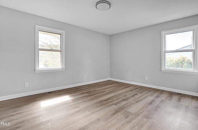 unfurnished room with light hardwood / wood-style flooring