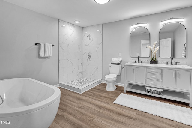 full bathroom featuring toilet, wood-type flooring, vanity, and plus walk in shower