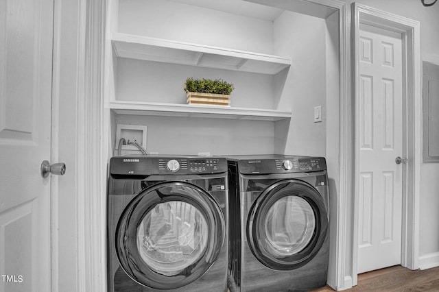 laundry room with dark wood-type flooring and independent washer and dryer