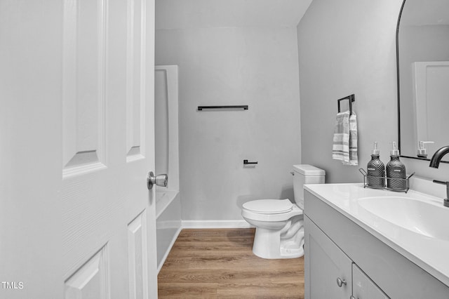 bathroom featuring hardwood / wood-style floors, vanity, and toilet