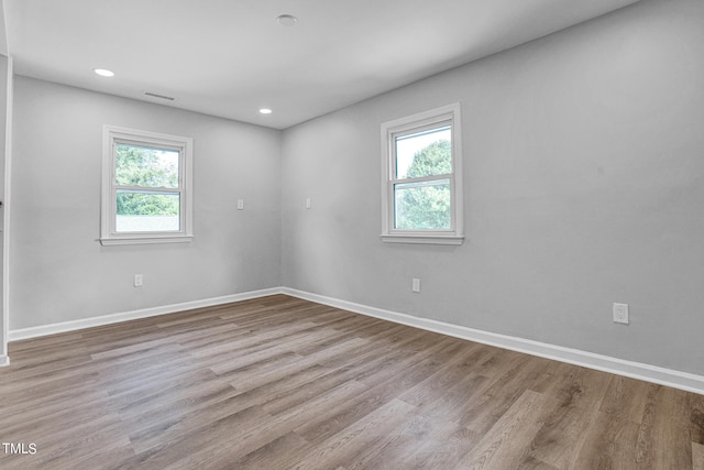 empty room featuring light hardwood / wood-style floors and plenty of natural light