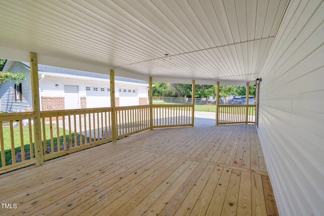 wooden terrace with a garage