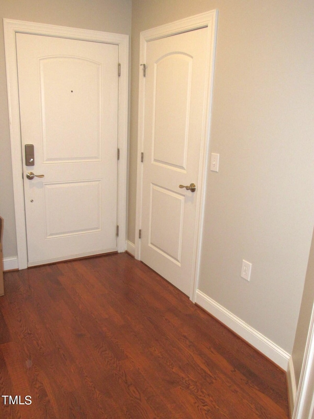 corridor with dark wood-type flooring