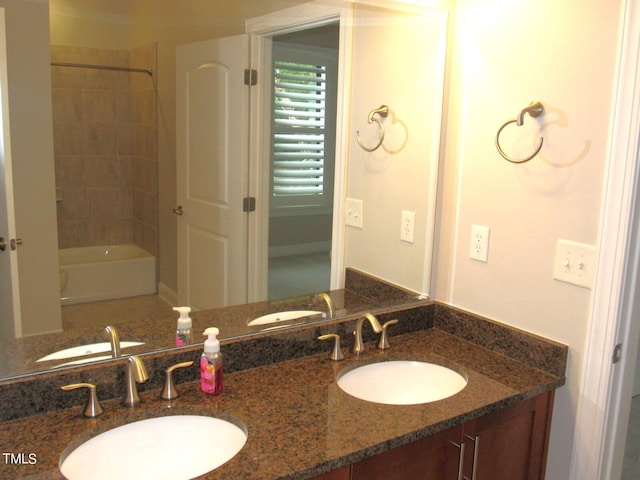 bathroom with vanity and tiled shower / bath combo