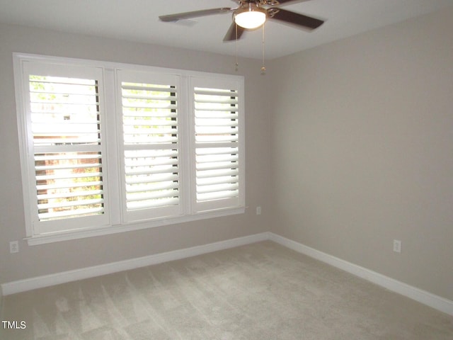 carpeted empty room with plenty of natural light and ceiling fan