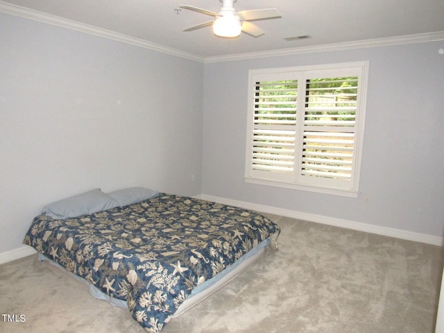 carpeted bedroom with crown molding and ceiling fan