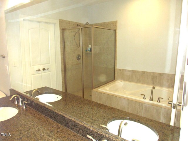 bathroom with vanity and plus walk in shower