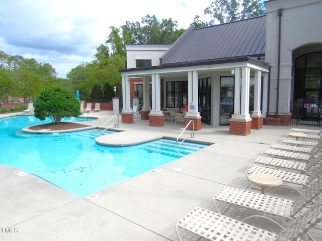 view of swimming pool with a patio area