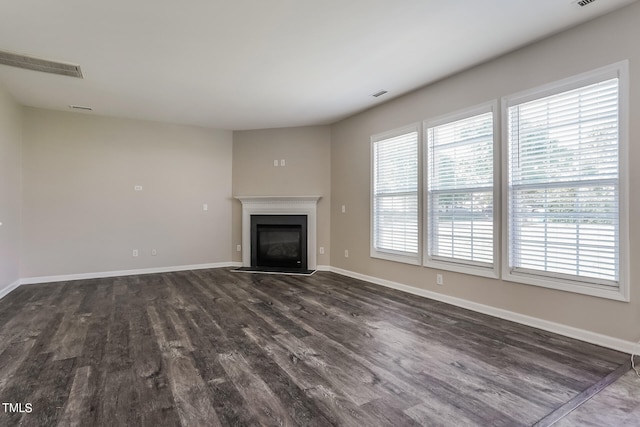 unfurnished living room with dark hardwood / wood-style flooring