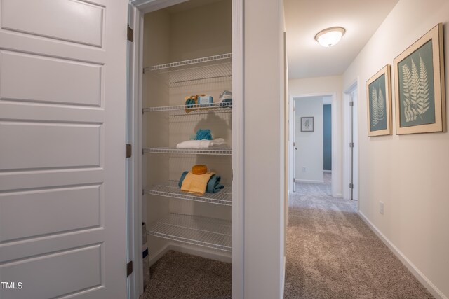 corridor featuring carpet flooring