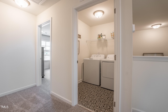 washroom with light colored carpet and washer and clothes dryer