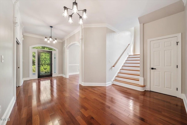 entryway featuring a notable chandelier, crown molding, and dark hardwood / wood-style flooring