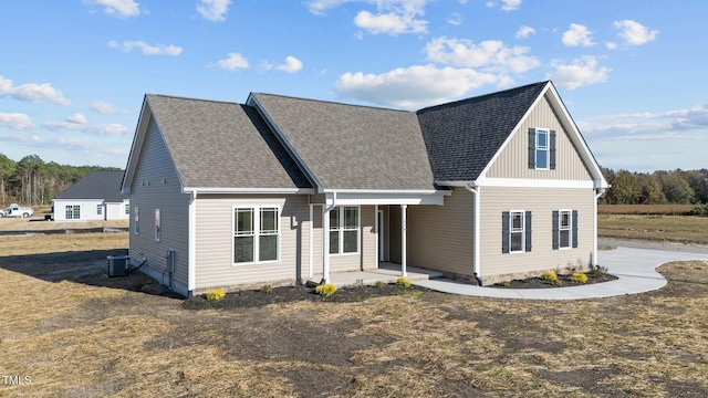 view of front of home with a patio and central AC