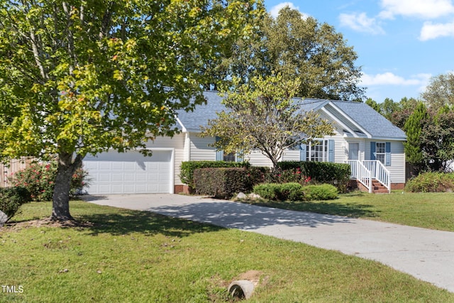 view of property hidden behind natural elements with a garage and a front yard