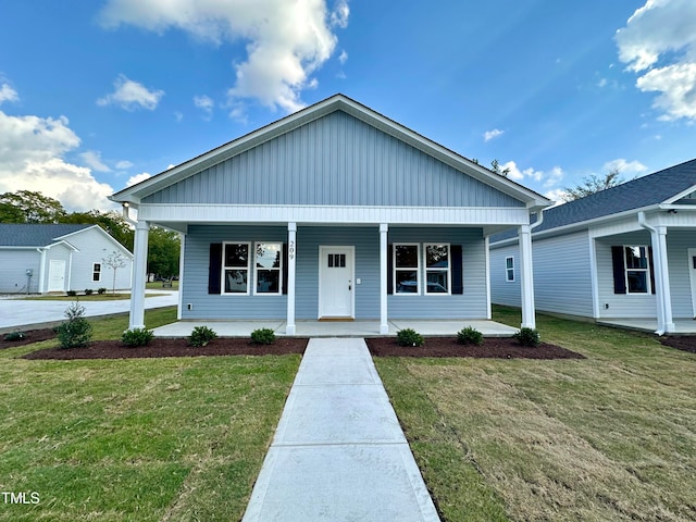 bungalow-style house featuring a front lawn and covered porch