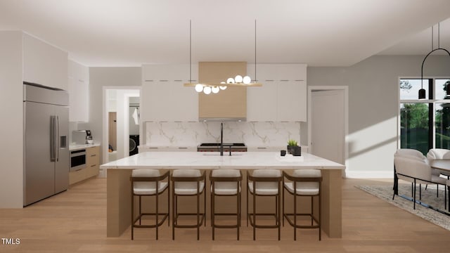 kitchen with a center island with sink, white cabinetry, light hardwood / wood-style flooring, and stainless steel appliances